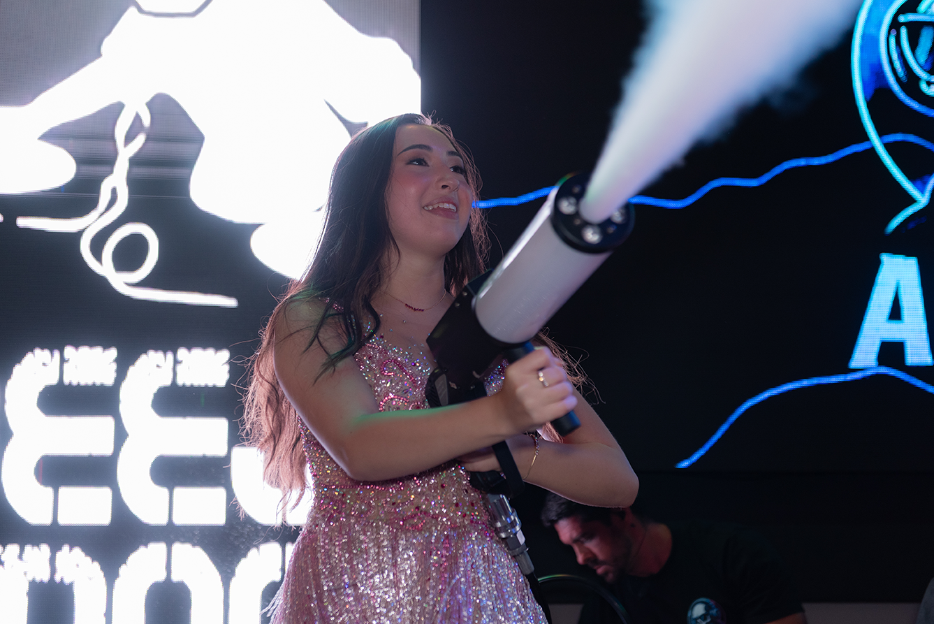 Aimée canta ao microfone durante a festa de 15 anos
