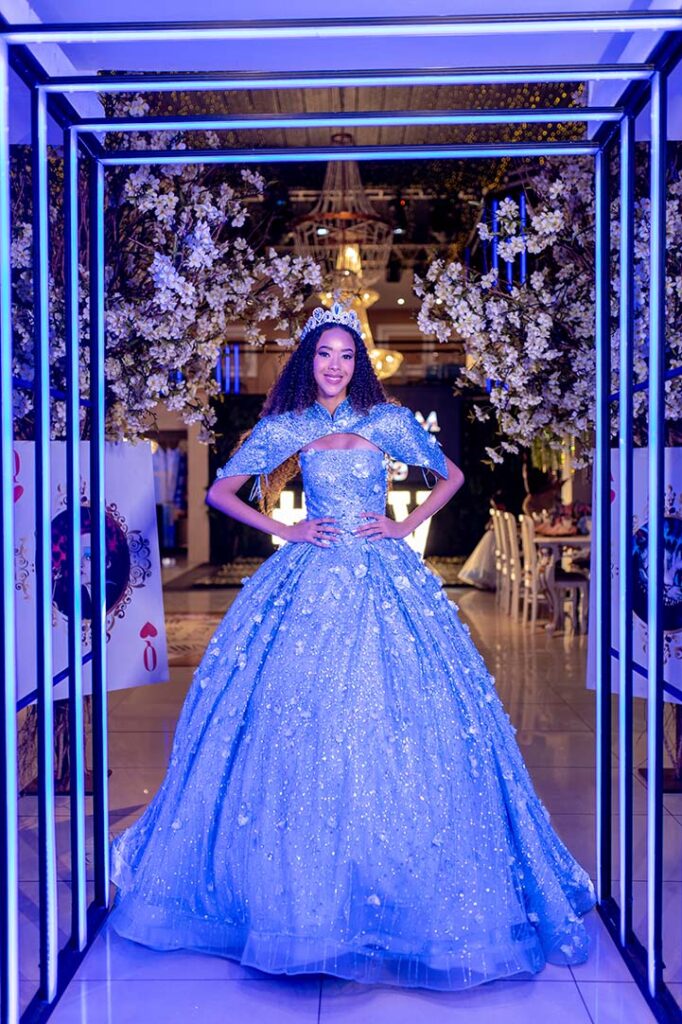 Debutante em vestido azul no corredor iluminado em azul
