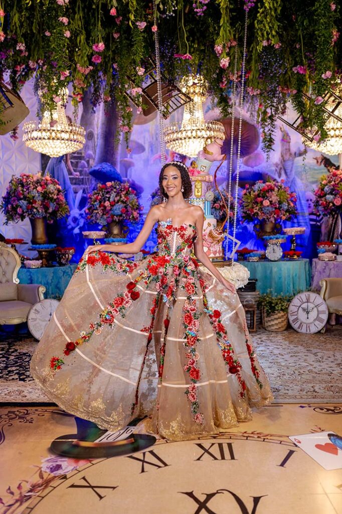 Kaylaine em vestido azul sobre o piso personalizado com relógio