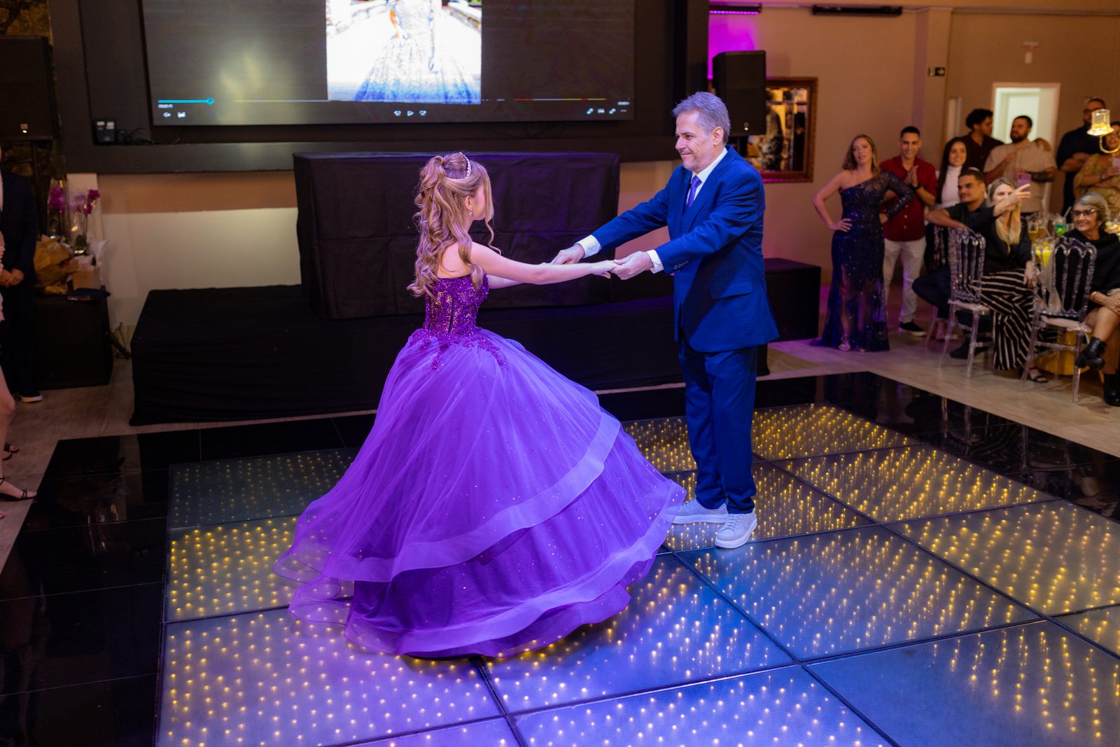 Vestido roxo da debutante em movimento durante a valsa
